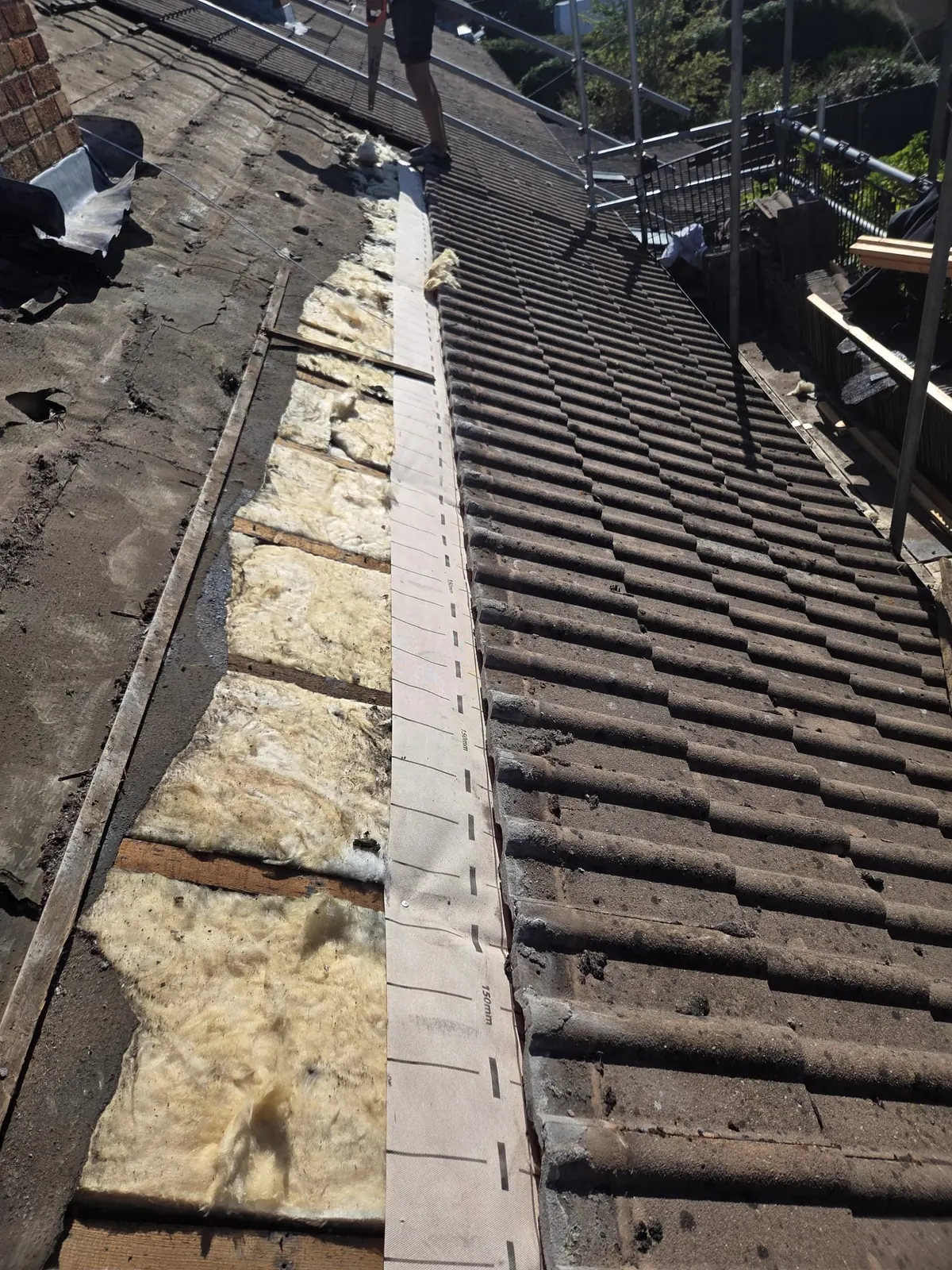 Old roof tiles being stripped for a re-roof in Bracknell