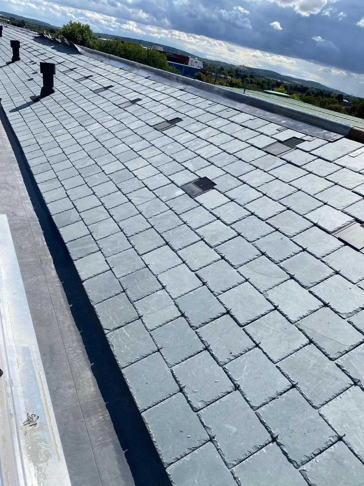 Lead ridge roll on a slate roof in Bracknell