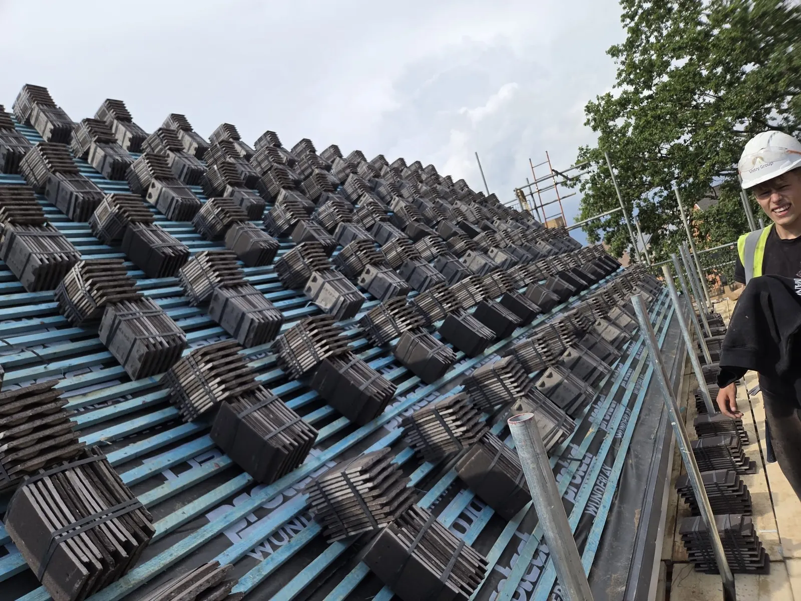 Roof tiles loaded onto new battens and membrane during a re-roof, Berkshire